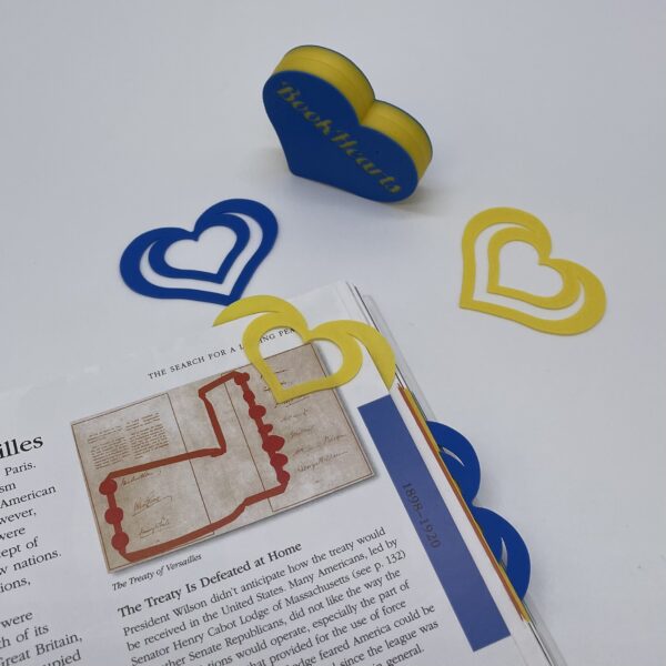Deep navy blue and bright yellow heart bookmarks, made with 3D printing precision.